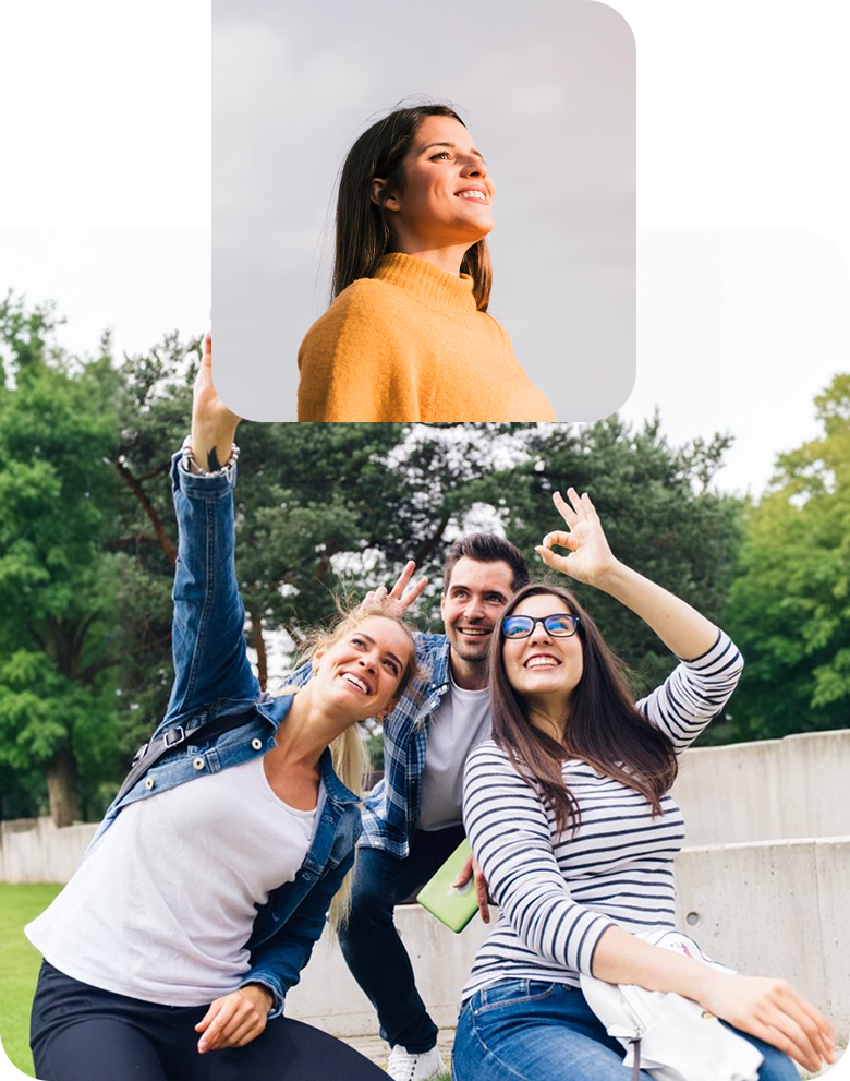 A smiling woman in a yellow sweater and friends enjoying time outdoors