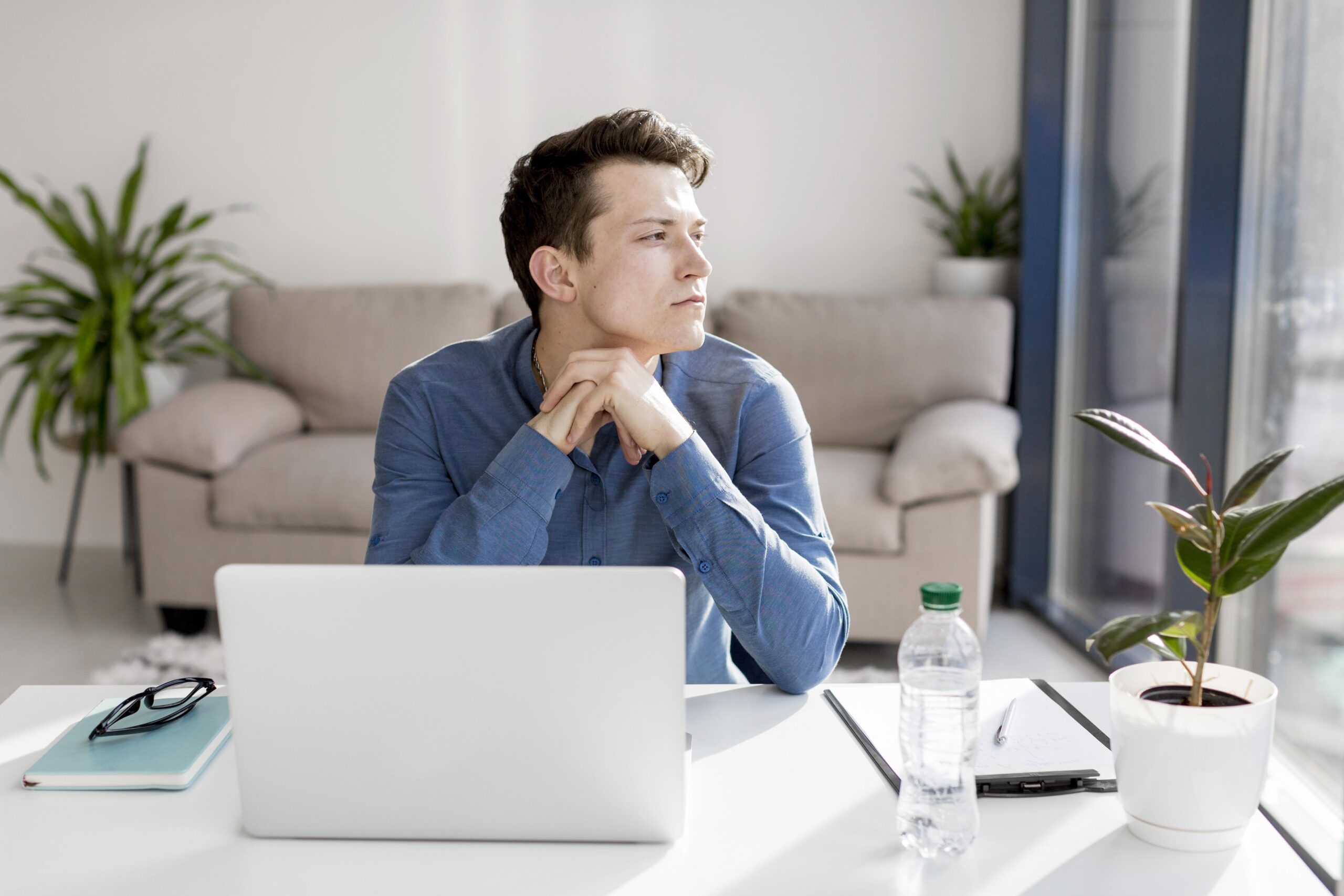 Young man reflecting at home