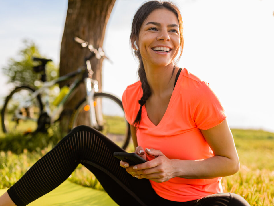 Smiling woman relaxing outdoors after exercise